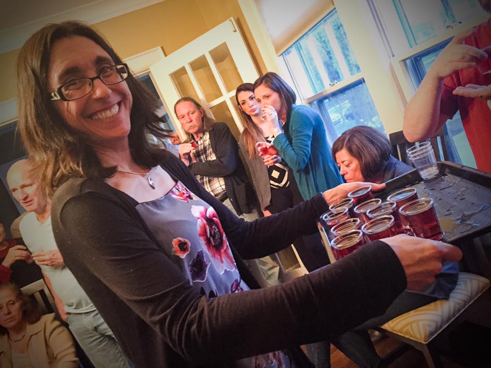 Board member Kathleen Koechlin serves up some delicious wine at a previous wine tasting fundraiser. 
