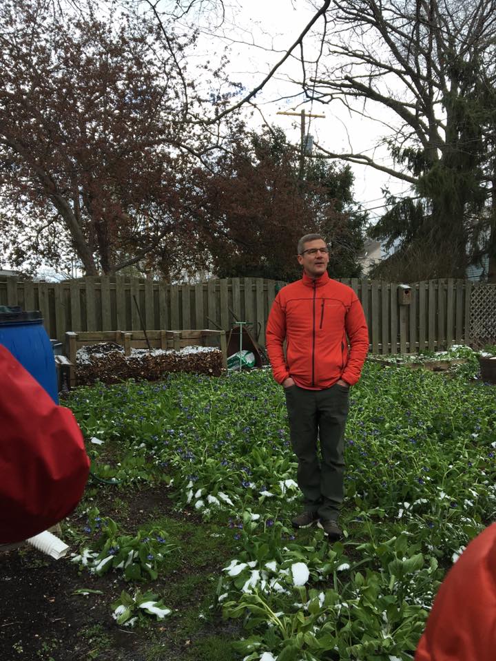 Mike Sapp standing in a bed of Kentucky bluebells as he tells us about rain barrels, composting and other at home earth friendly ways to live.