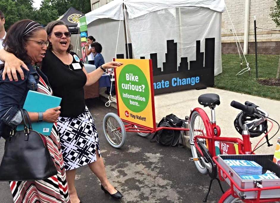 Catherine shows off our new outreach bike to Sandra López, Legislative Analyst, City Council Division of Community Engagement, at the Smart City award press release event. 