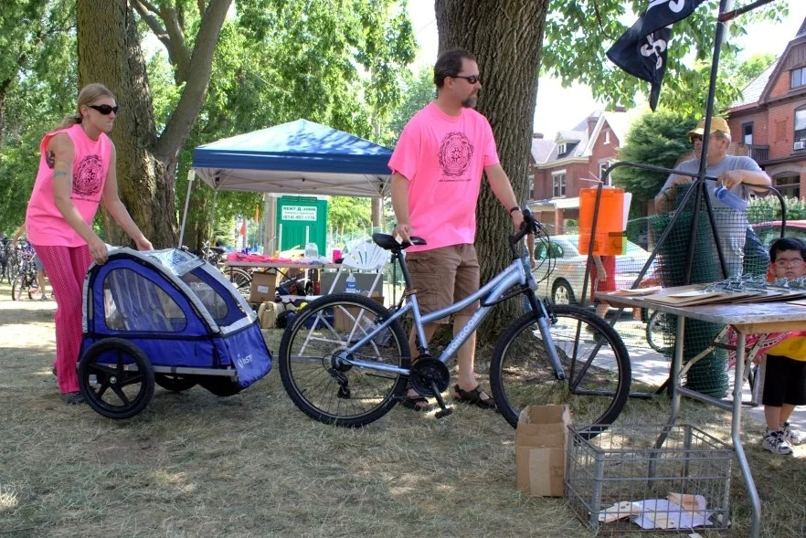 Rocking a flaming pink tee at a Comfest bike valet. 