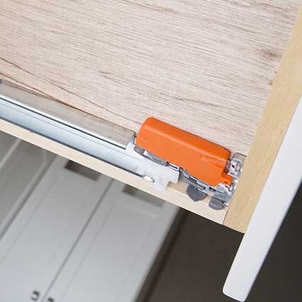 When glides are mounted underneath, the drawer box can be wider. Plus, undermount glides don't catch dirt the way side mount glides do.