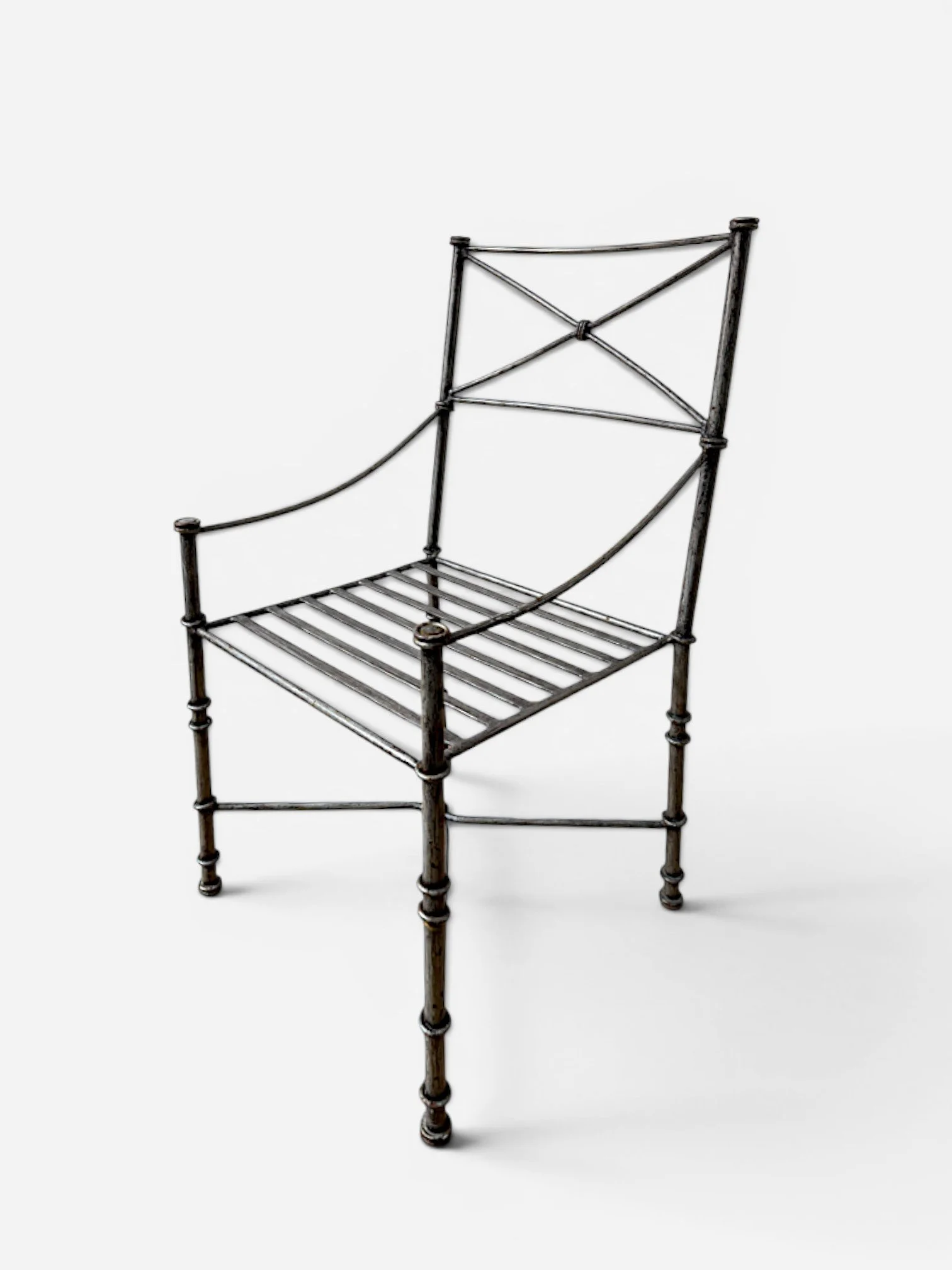 AGED IRON ARMCHAIR