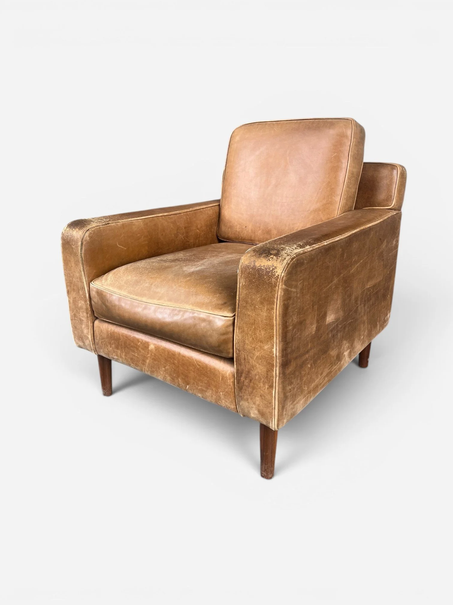 WORN LEATHER ARMCHAIR