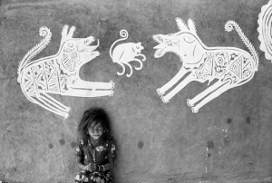 A young girl in front of Mandana paintings, Rajast | Modern silver gelatin print | 10.5" x 15" | 1970
