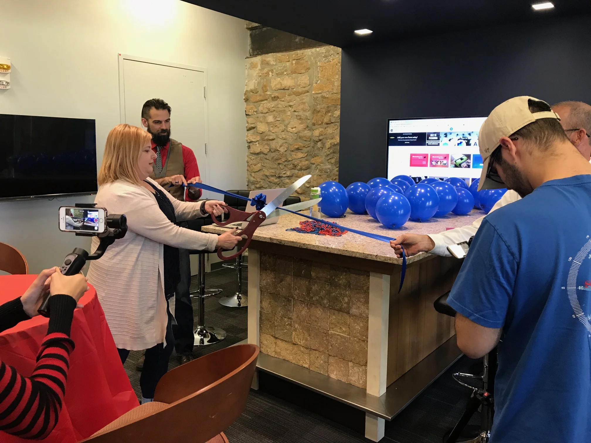 Lawrenz cut the ribbon for the J-School's new tech hub, the JBar, in September with an assist from Anthony Whaley, lab specialist. (See photo gallery of the installation below.)
