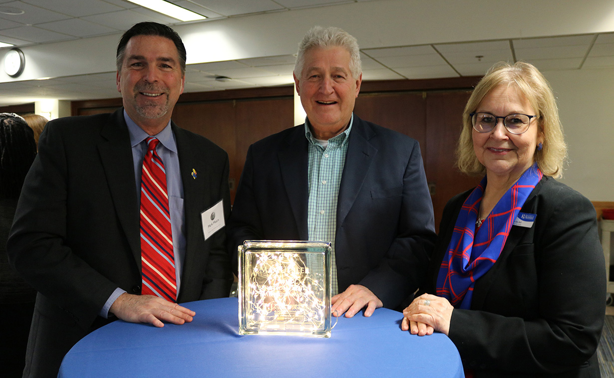 1984 J-School graduate Mark Mears, (from left) Associate Professor Max Utsler and Dean Ann Brill.