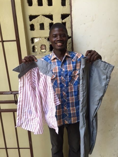 Rod Loin shows off the school uniforms he made.