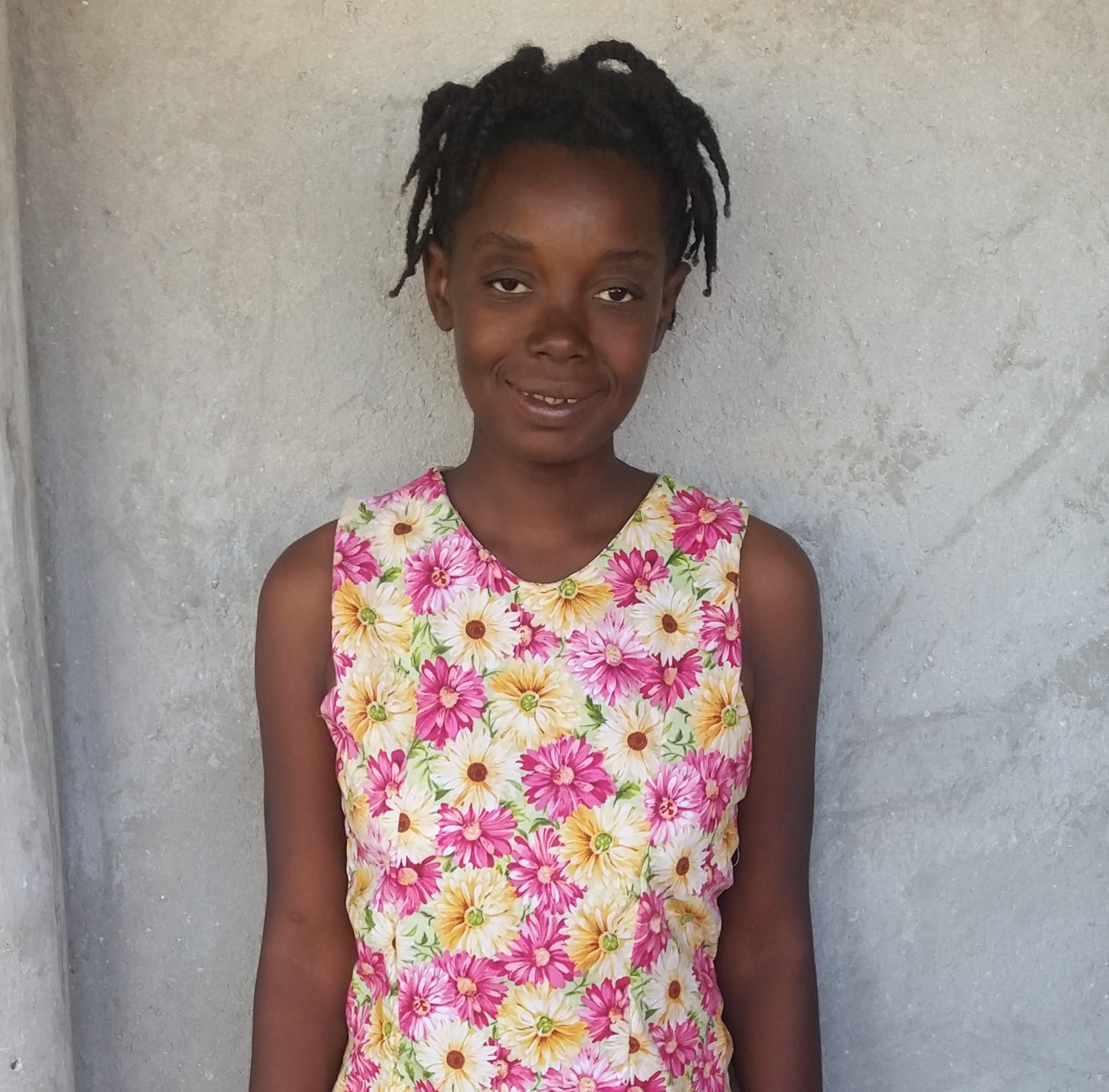 Micheline I could not sew anything before. Now I can. My family is happy when I make beautiful things. (Micheline made the dress she's wearing.)