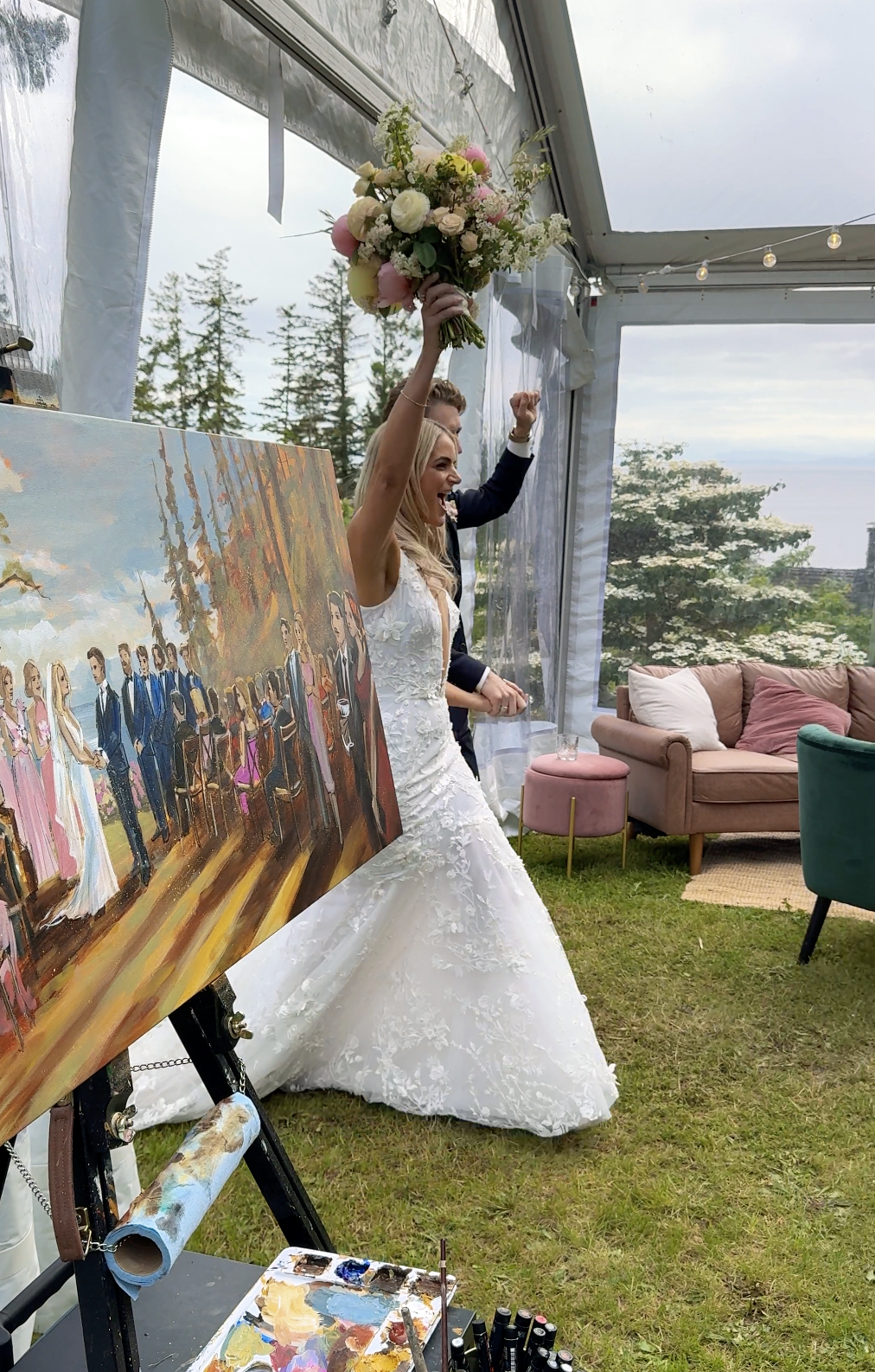 Olga Rybalko painting live at outdoor wedding in a forested setting — guests watching live painting being created