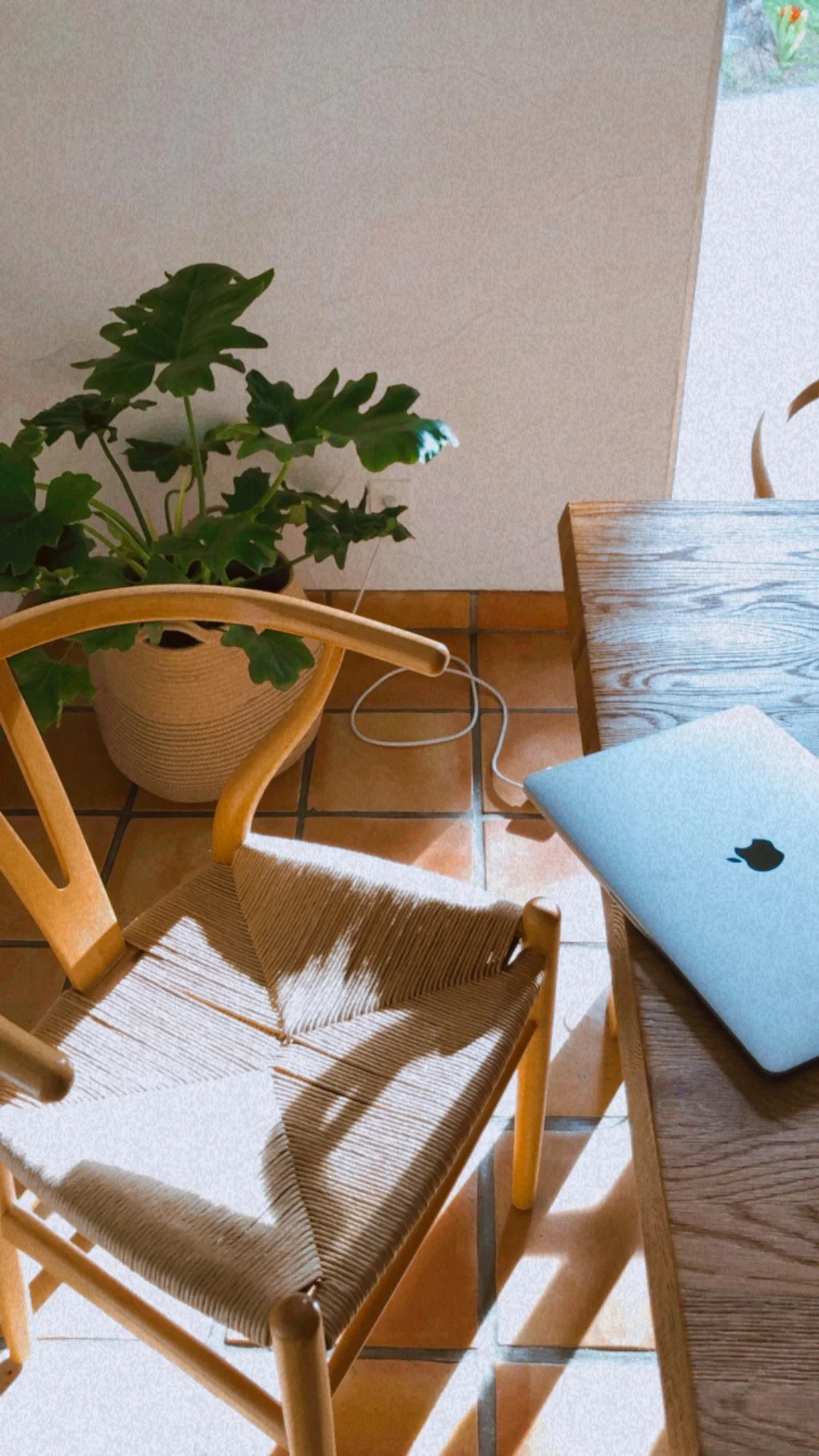 Laptop on a chair in a bright home workspace