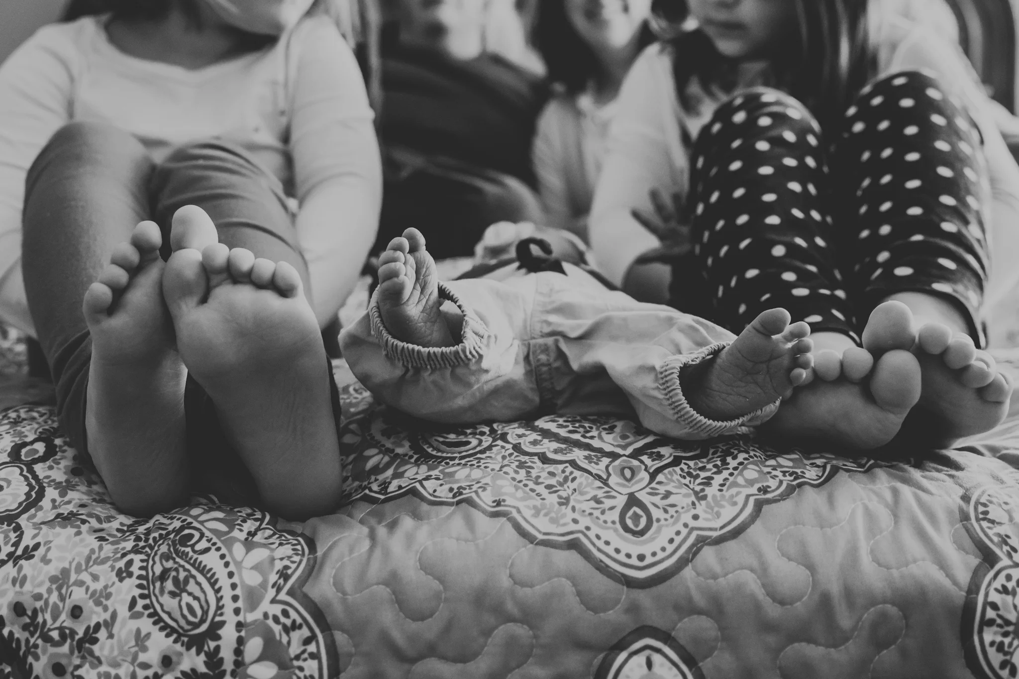 Baby and family on bed in Kansas City.