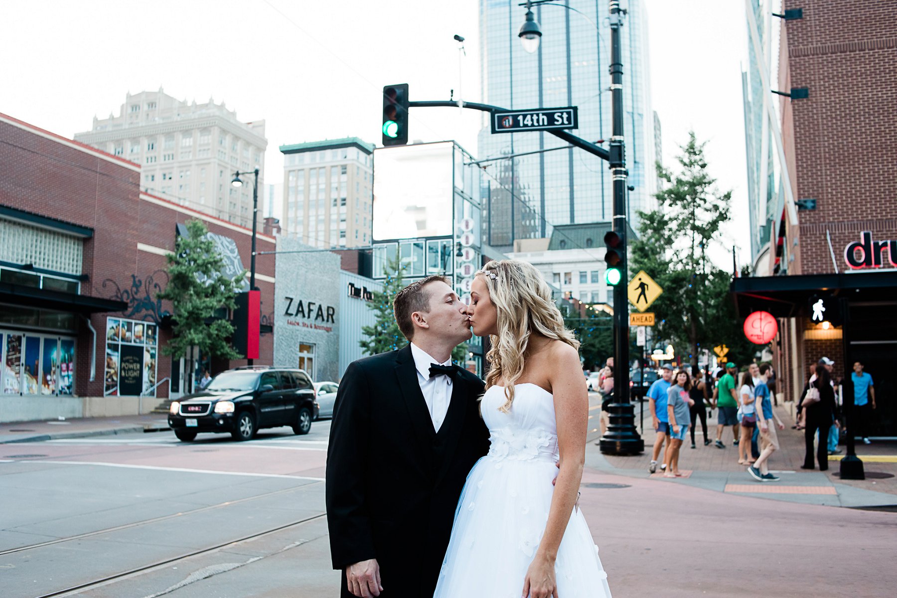 Bride and groom embrace on street in Kansas City by Merry Ohler