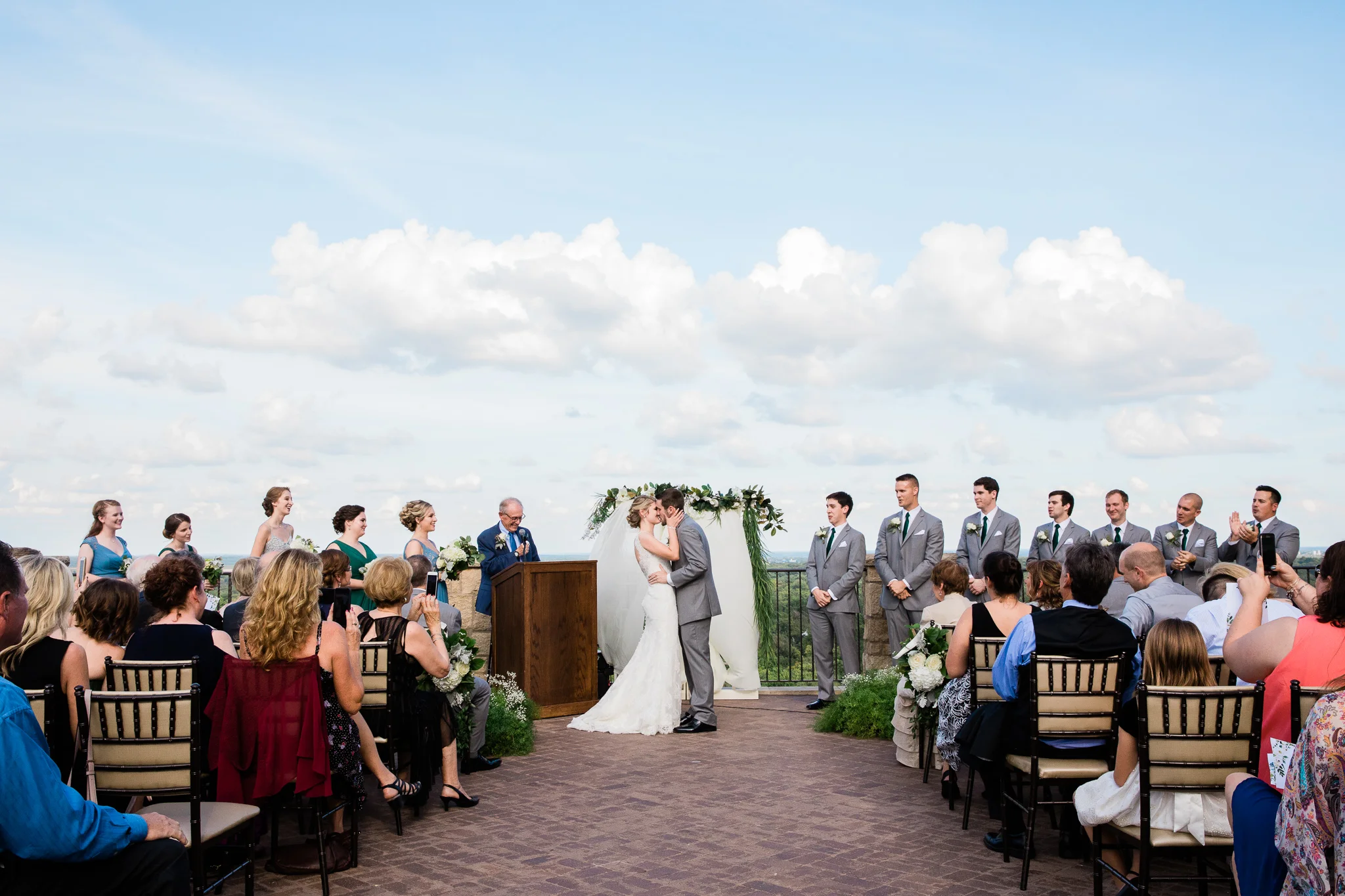 Bride and groom kiss during rooftop ceremony in Lawrence, KS.