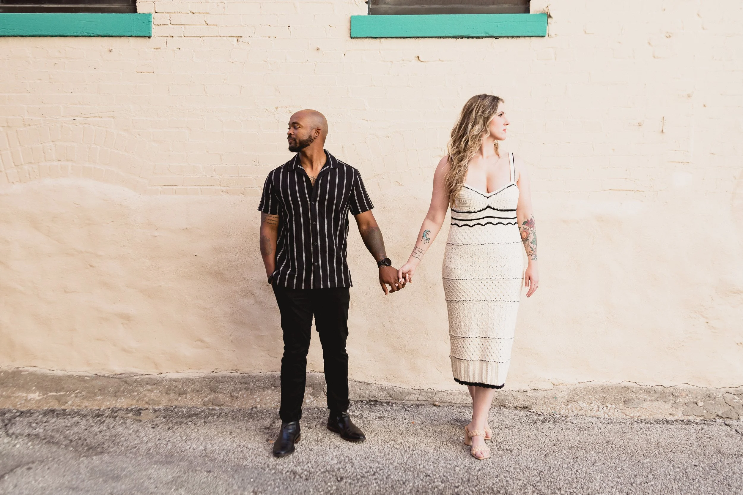 Engaged couple holds hands in Crossroads District engagement session.