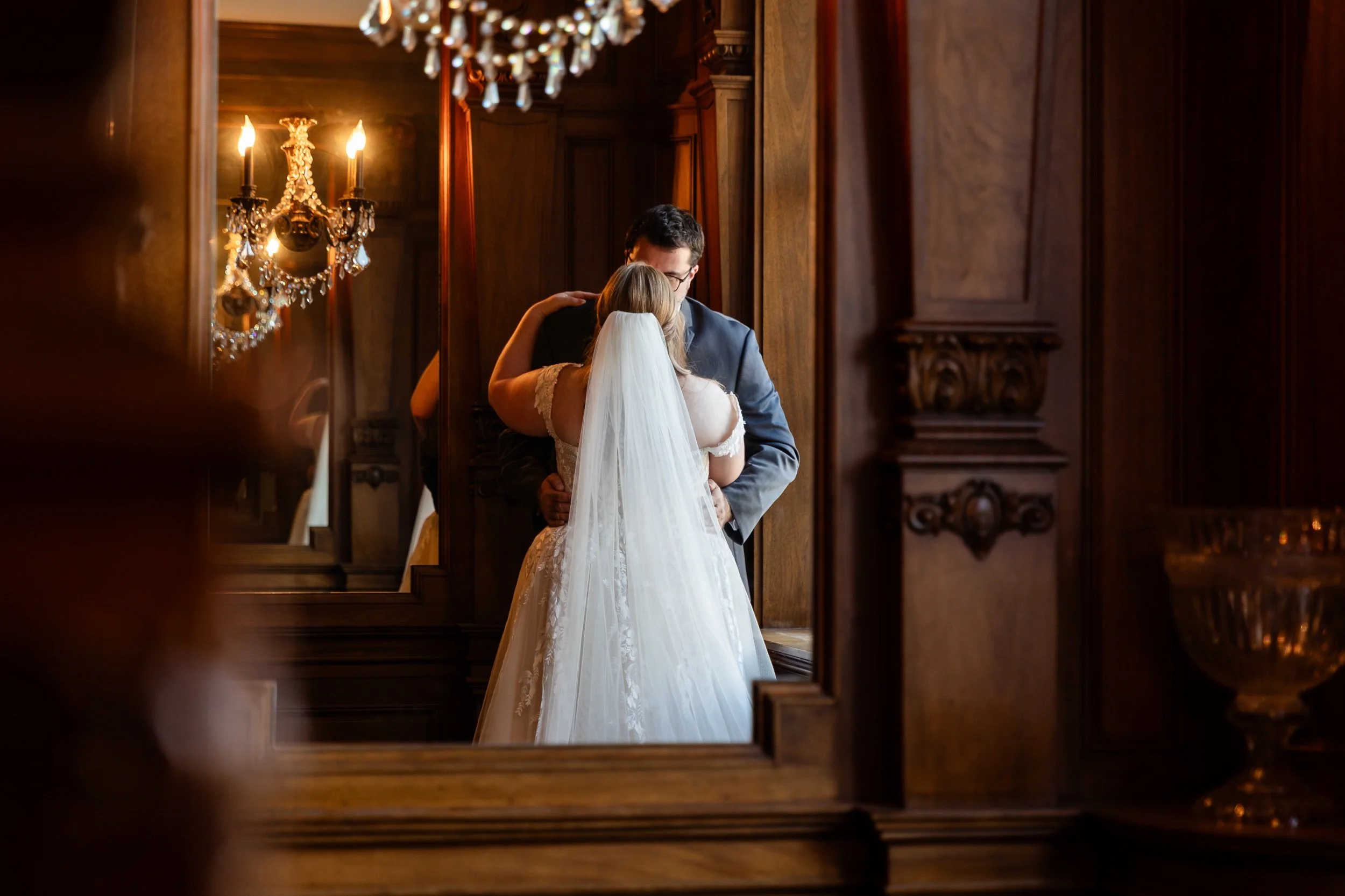 Bride and groom embrace during first look at Loose Mansion.