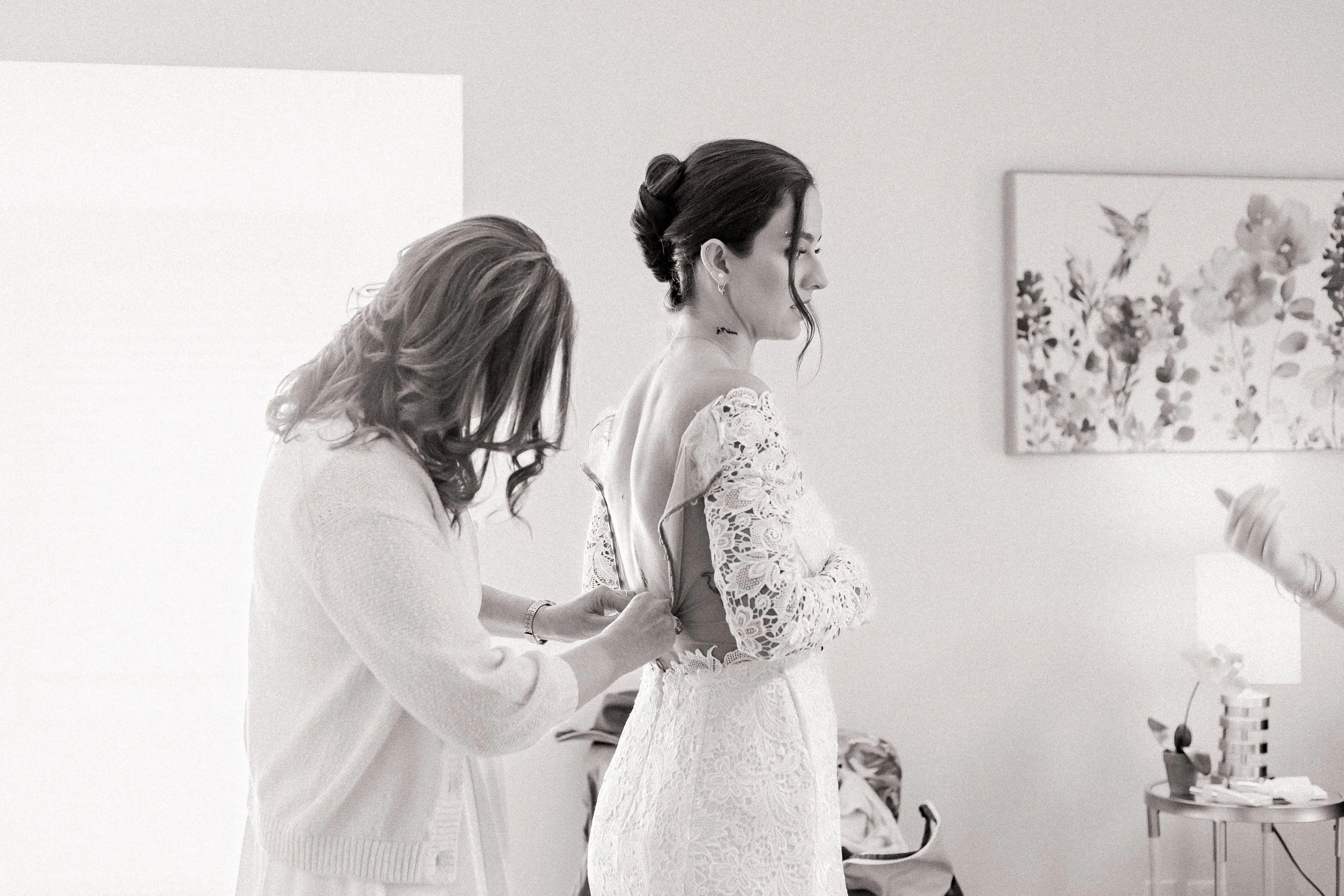 Bride's mother helps with dress at private estate wedding in Mission, KS.