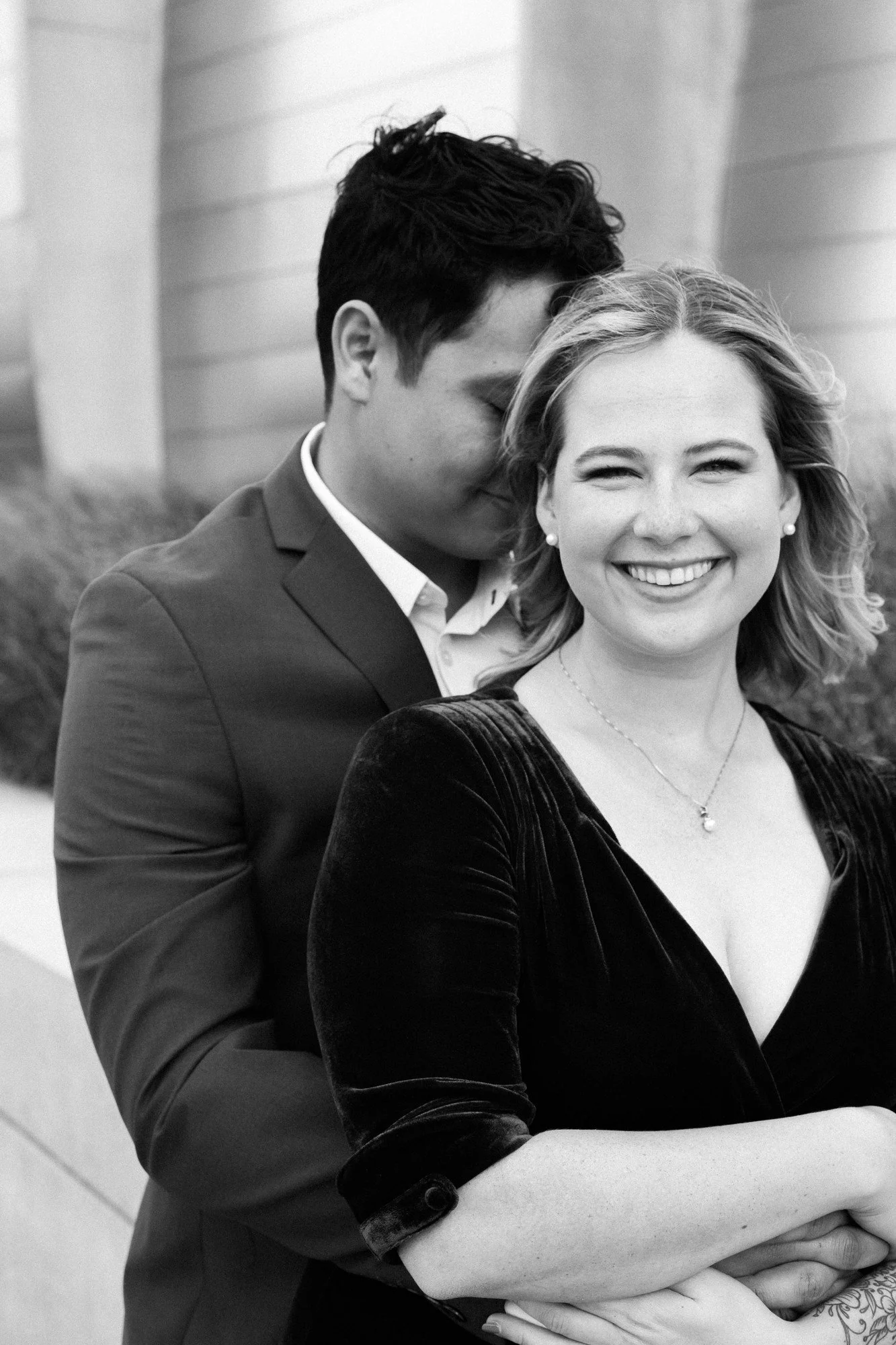 Couple embraces during Kansas City engagement photography session in the Crossroads District.