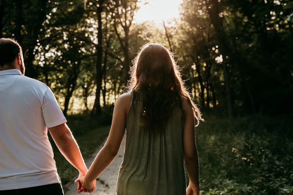 Couple holding hands during a Kansas City engagement session in Liberty, Missouri..