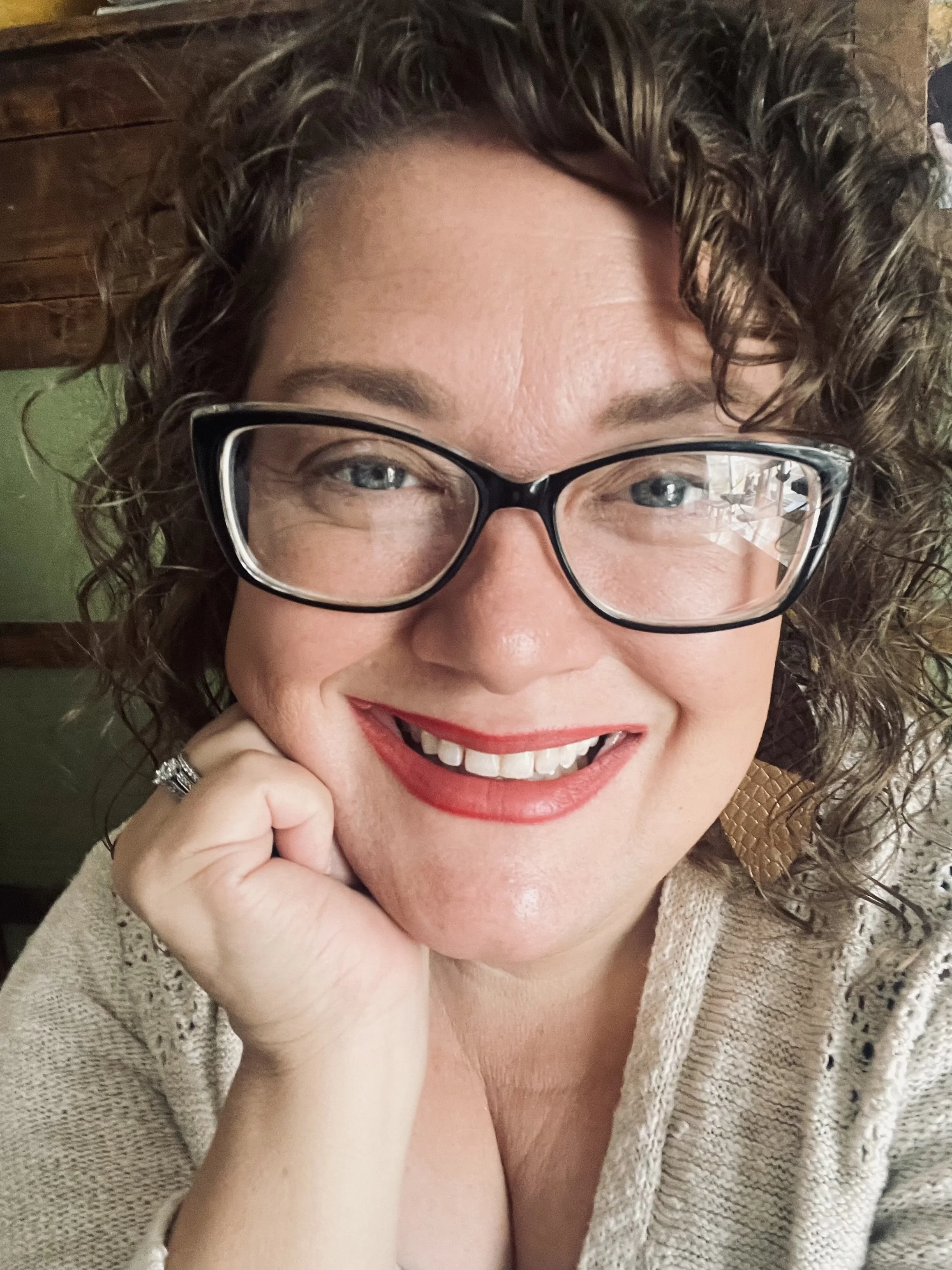 Kansas City wedding photographer, Merry Ohler, smiles outside.