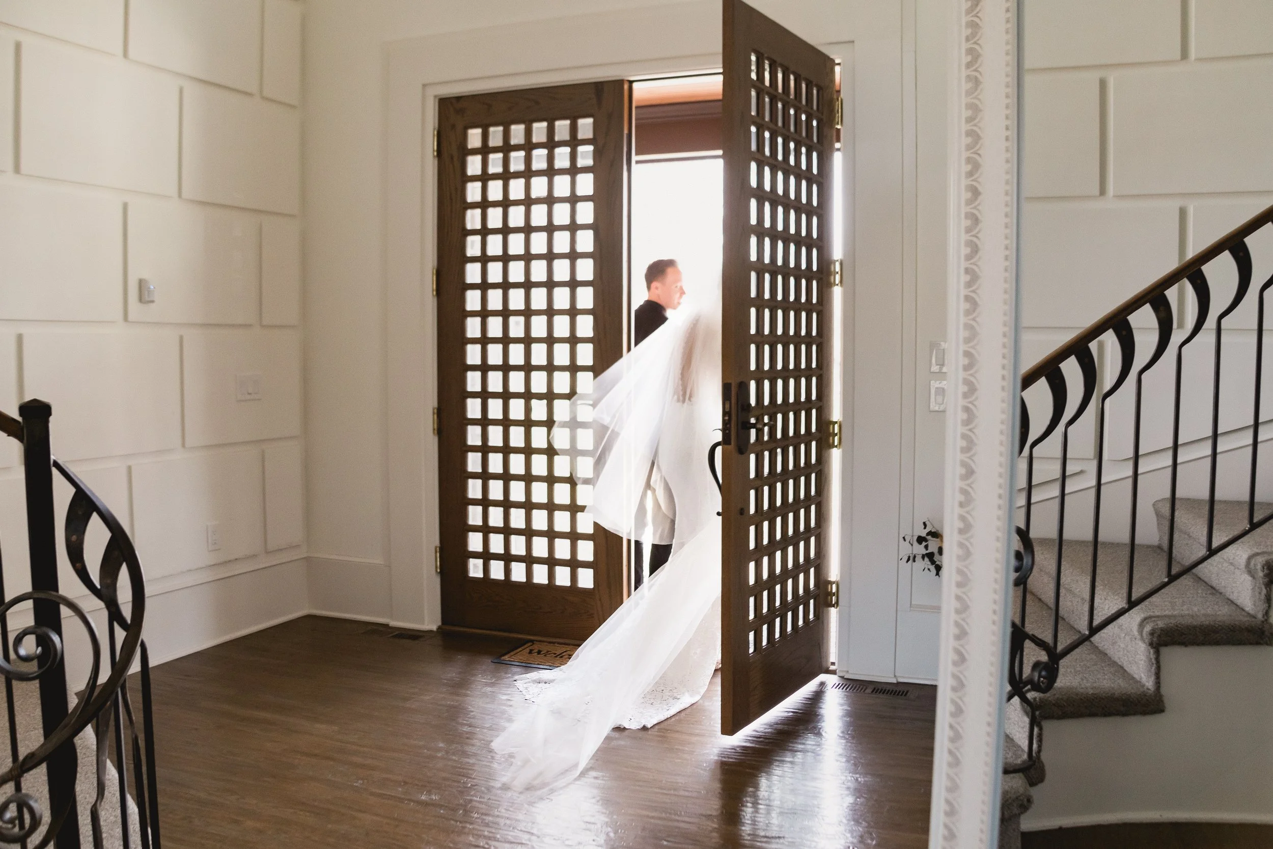 Bride and groom exit house after private estate wedding in Olathe.