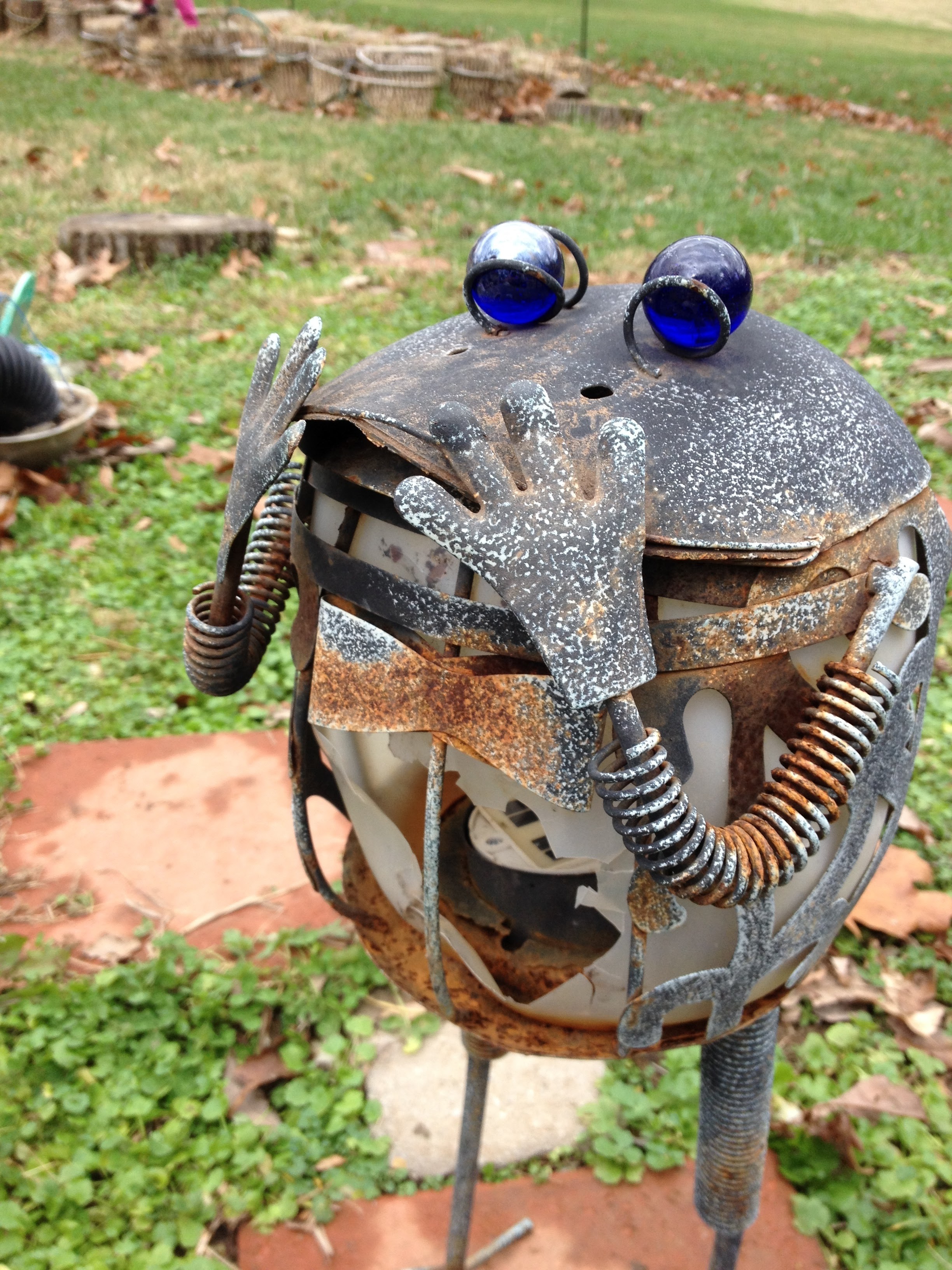 Frog statues in the garden aren't just cosmetic. They are light enough that almost any student can pick them up and move them. Being encouraged to decorate the garden before or after tending to the plants can engender a feeling of attachment to the garden and the plants therein.