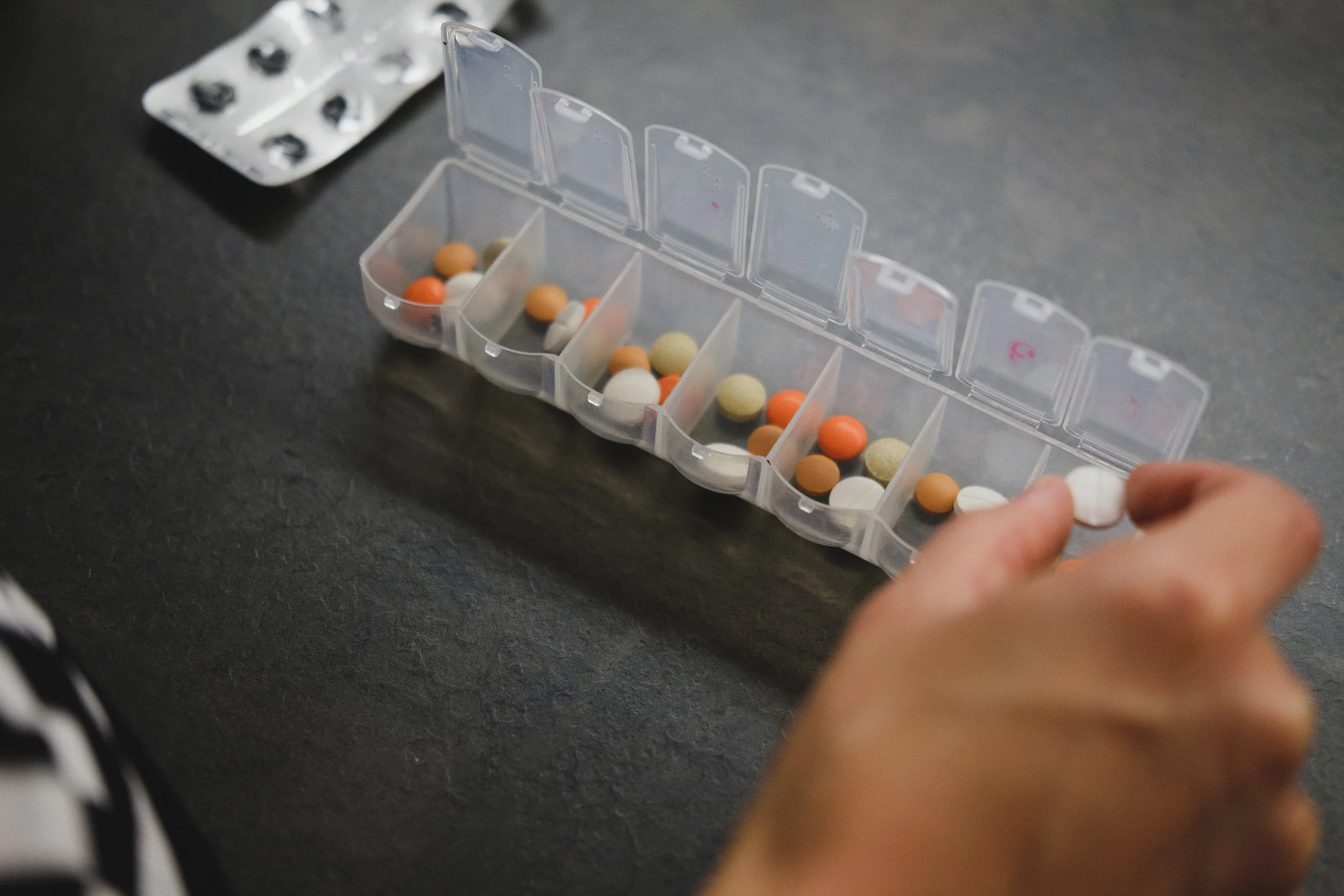 Person organizing their medications