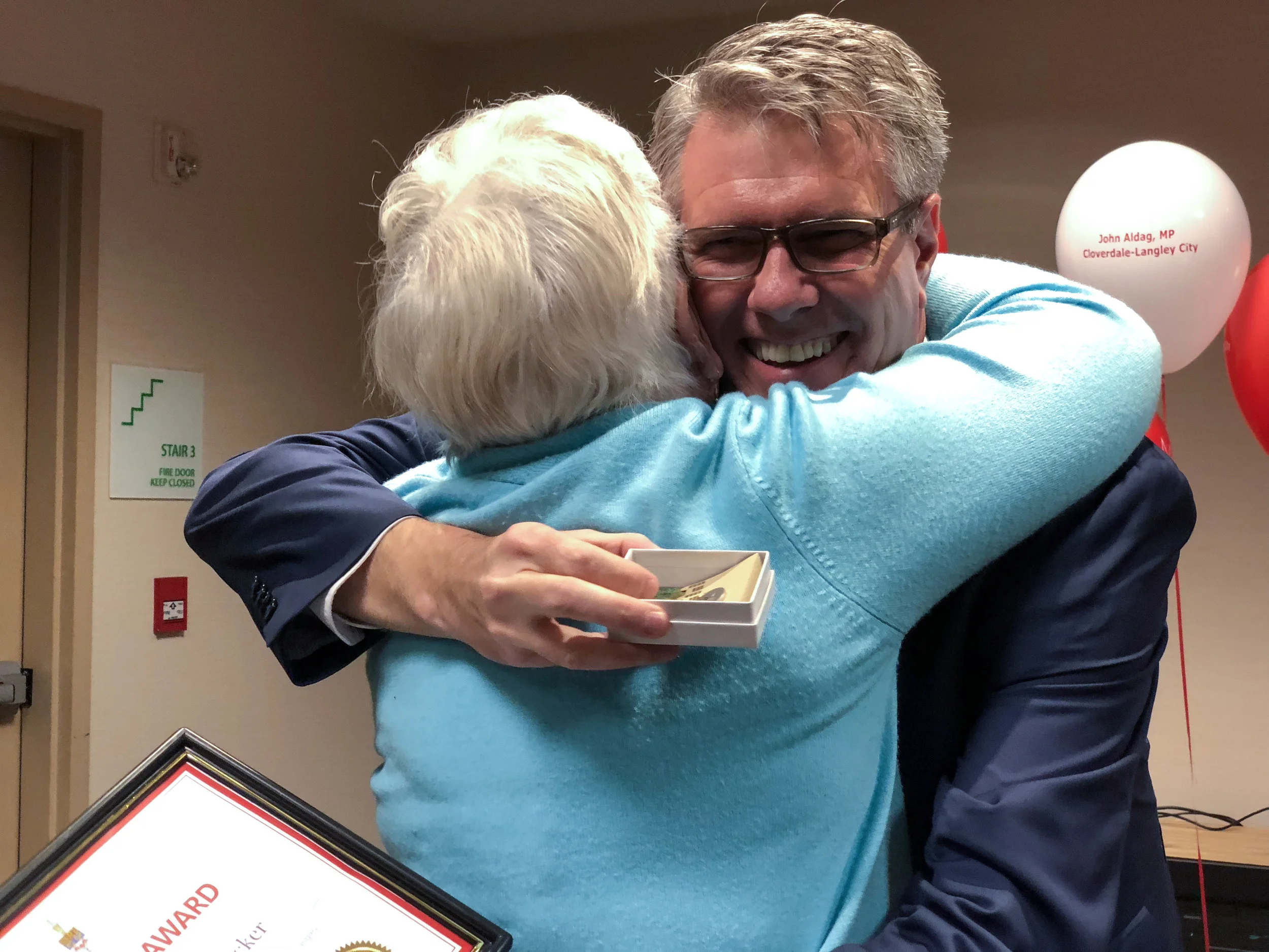 John Aldag hugs Cloverdale - Langley City senior citizen