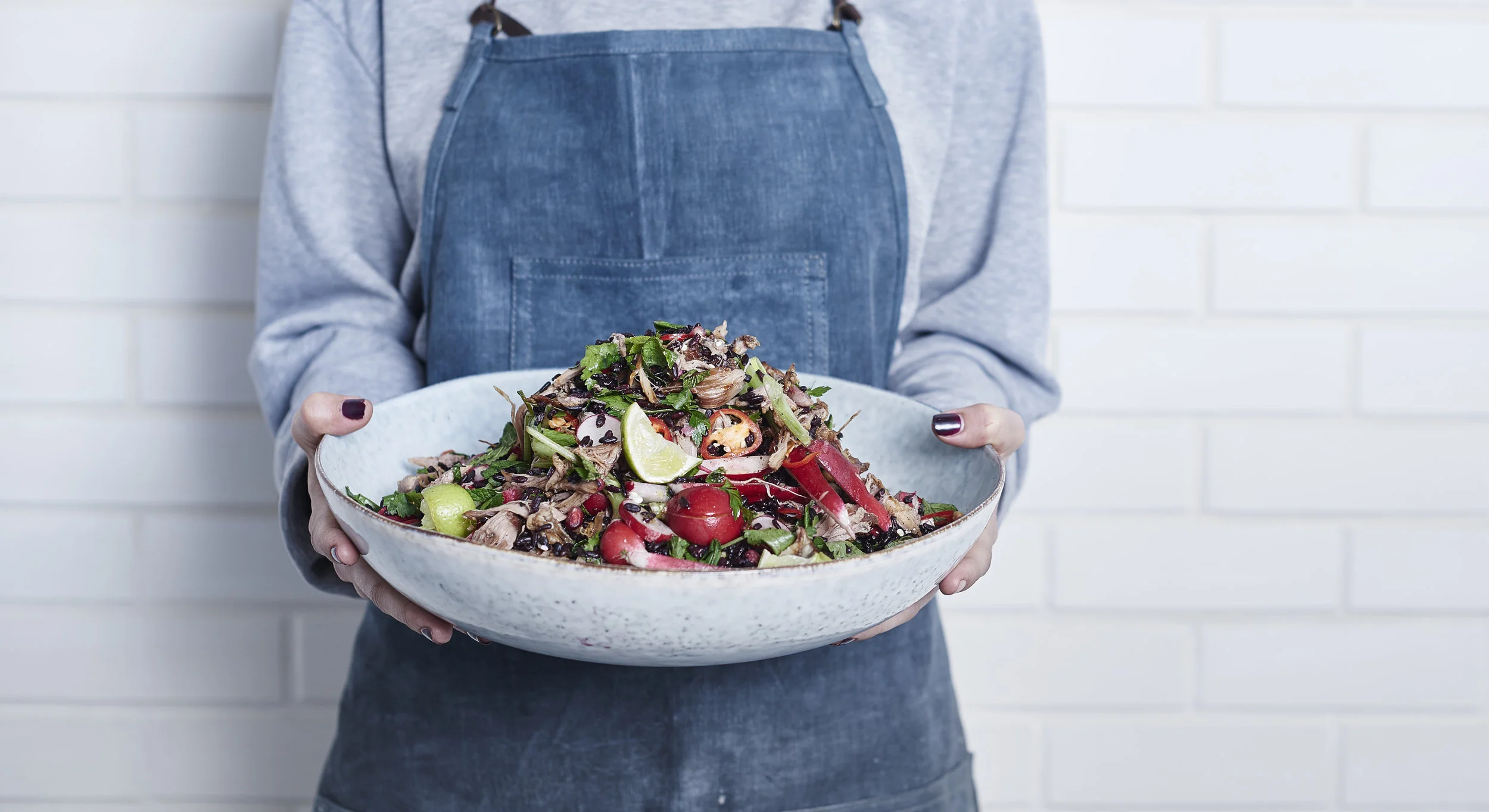 Salad bowl and apron available at the House Curious shop in the kitchen section.