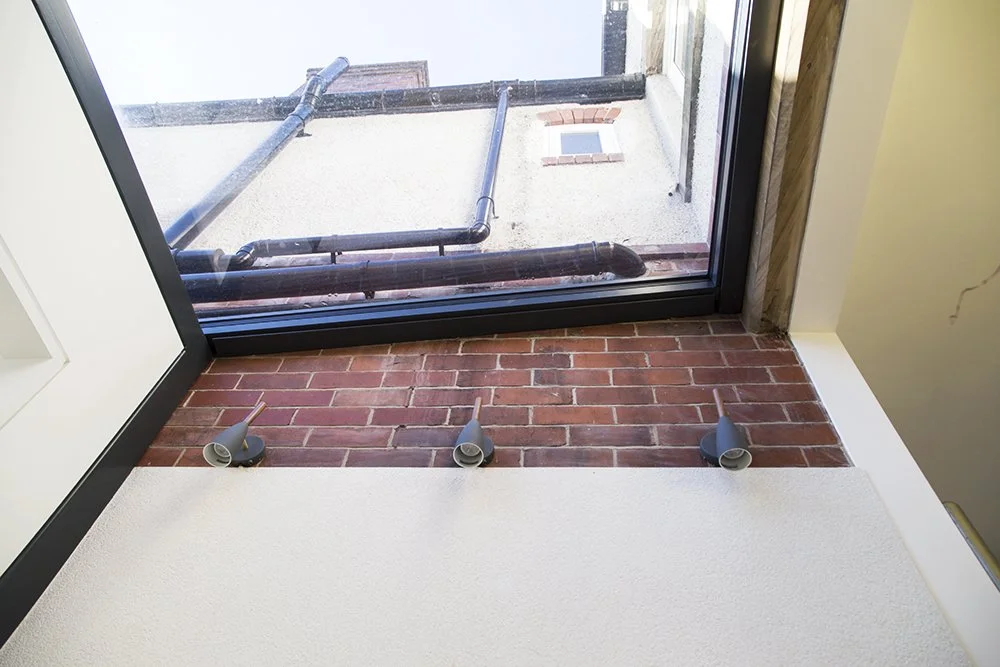 A glazed extension to a Victorian terrace in Sheffield housing a WC and entrance hall.
