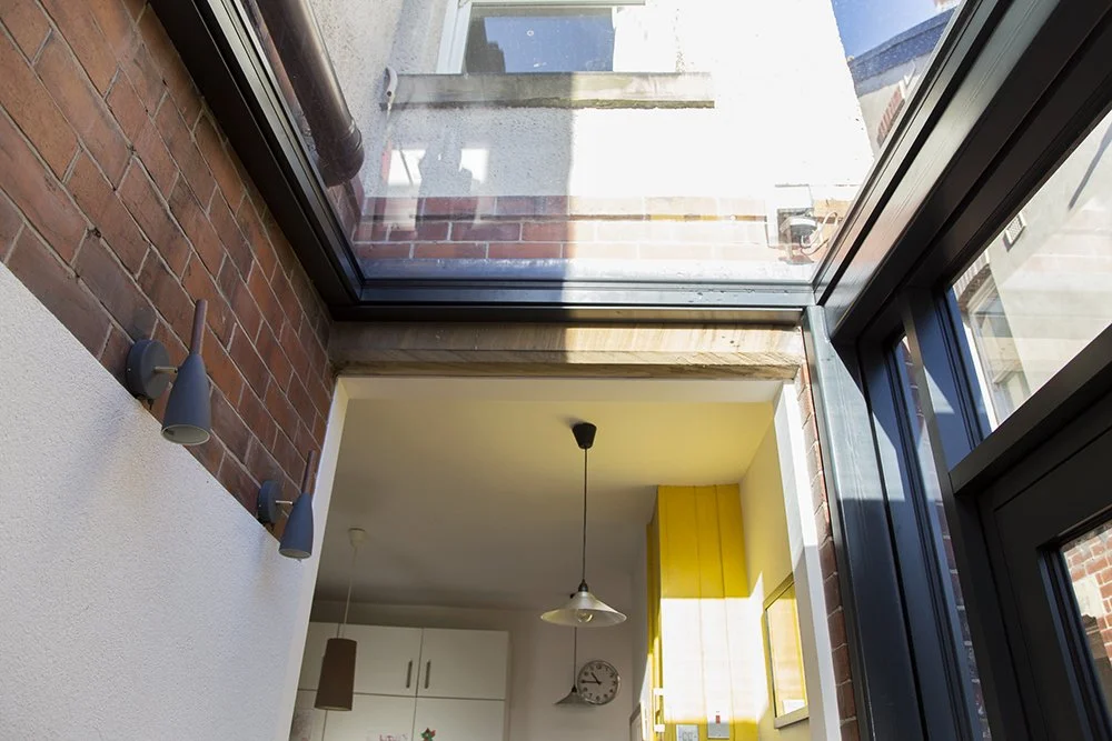 A small timber and glass extension to a Victorian terrace in Sheffield housing a WC and entrance hall.