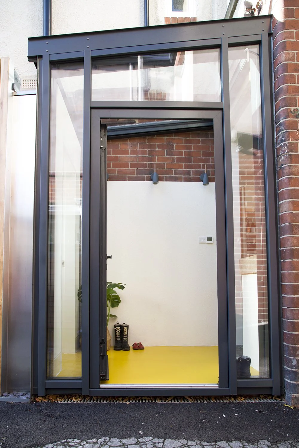 A small extension to a Victorian terrace in Sheffield by SJW Architects, with a bold and bright yellow rubber floor.