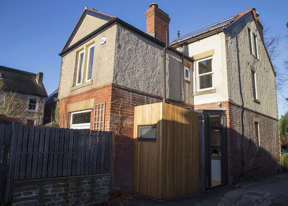 A small timber and glass extension to a Victorian terrace in Sheffield housing a WC and entrance hall.