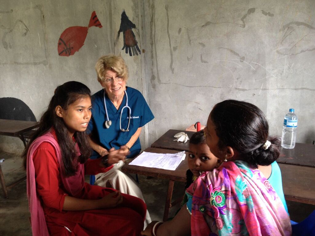 Dhamadina helps Dr. Joyce interview a patient.jpeg