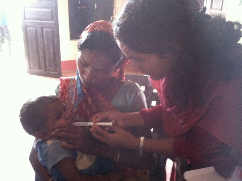 Sudharma, one of our ANM nuns, administers a dose.jpeg