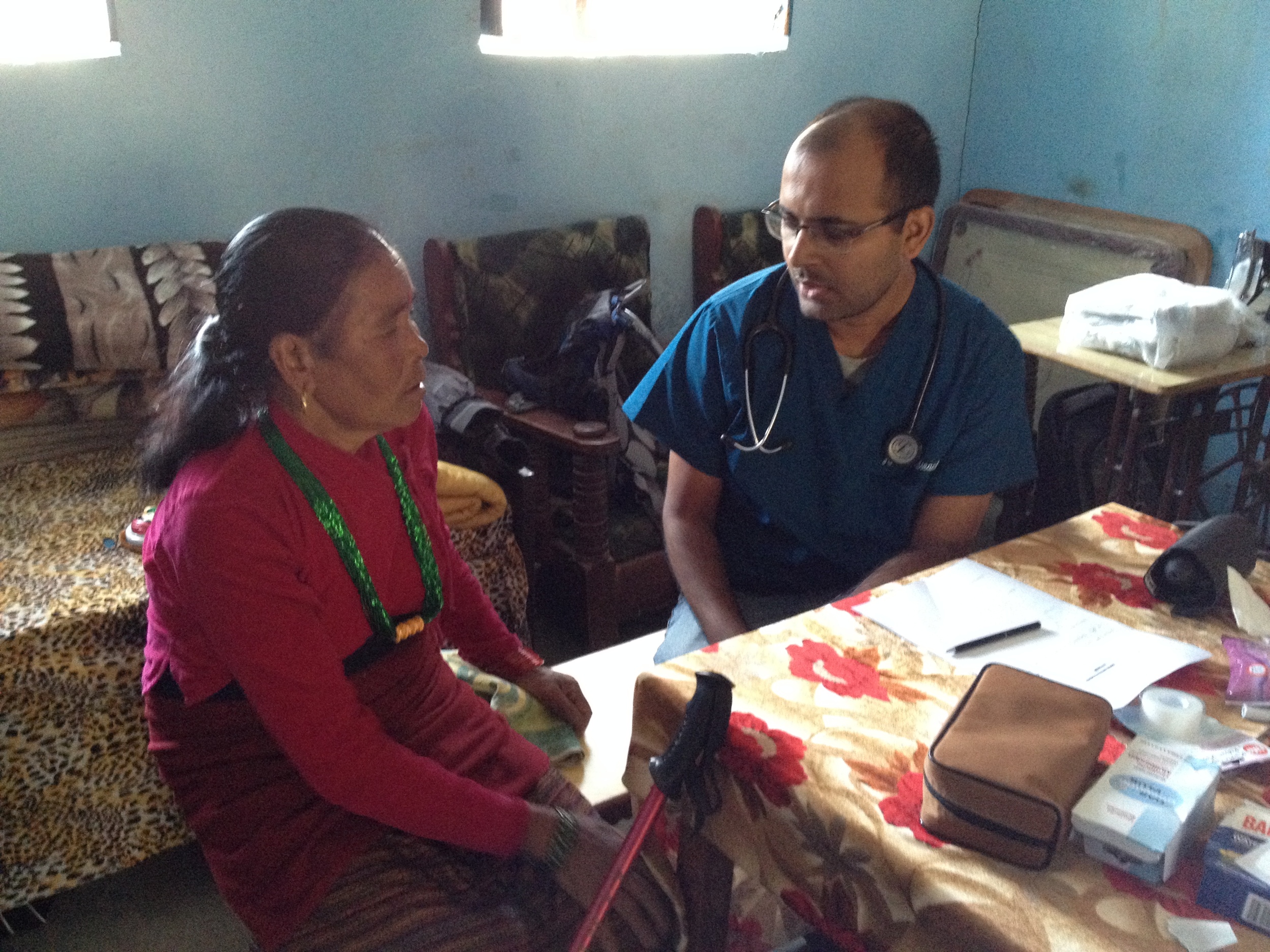 Bidur explains to a patient.JPG