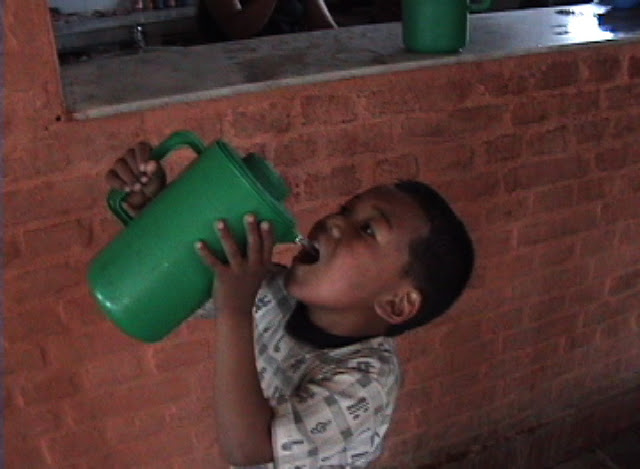 Boy drinking from pitcher.JPEG