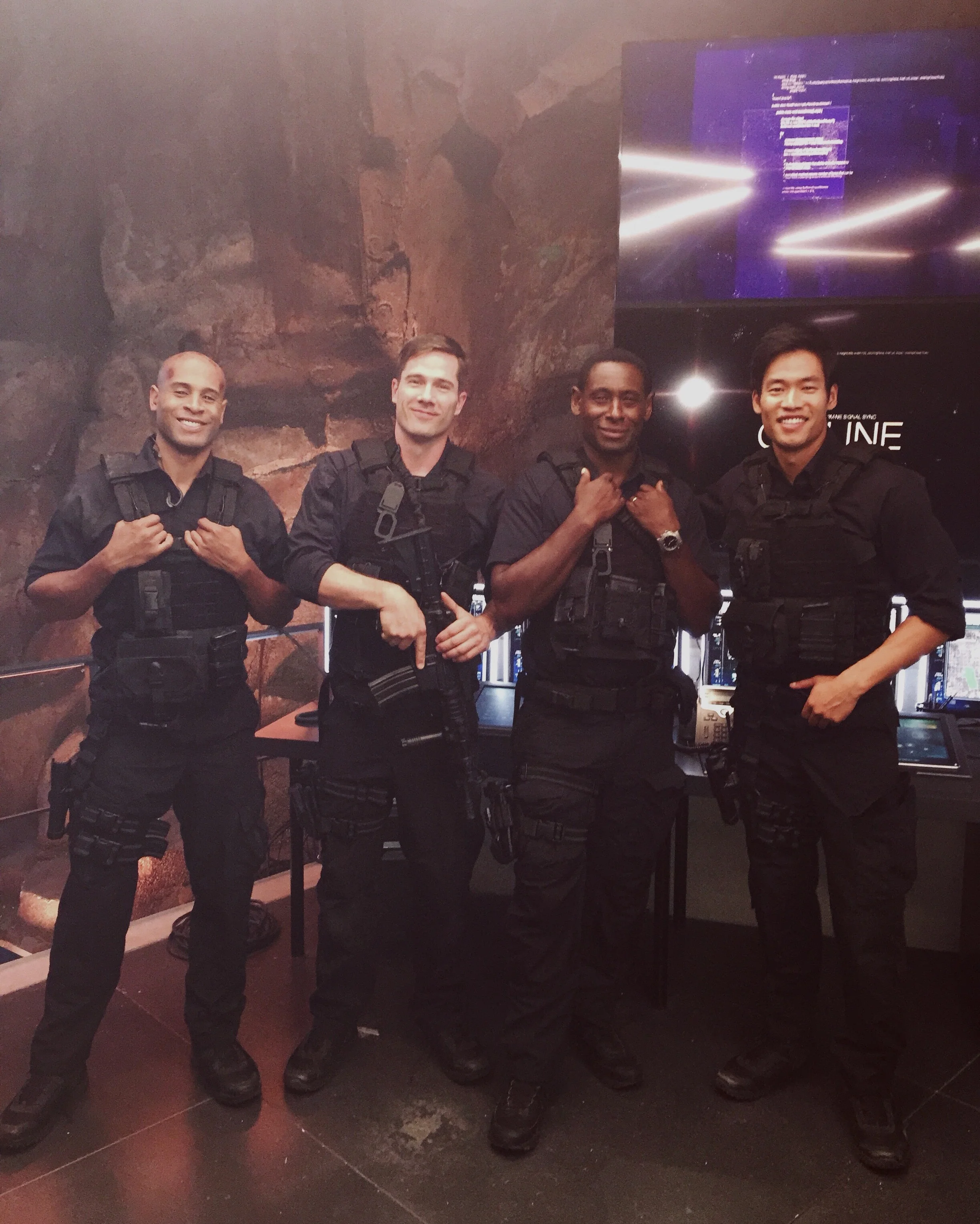 Actors Ayo Sorrells, Luke Macfarlane, David Harewood, and David Lim on the set of Supergirl