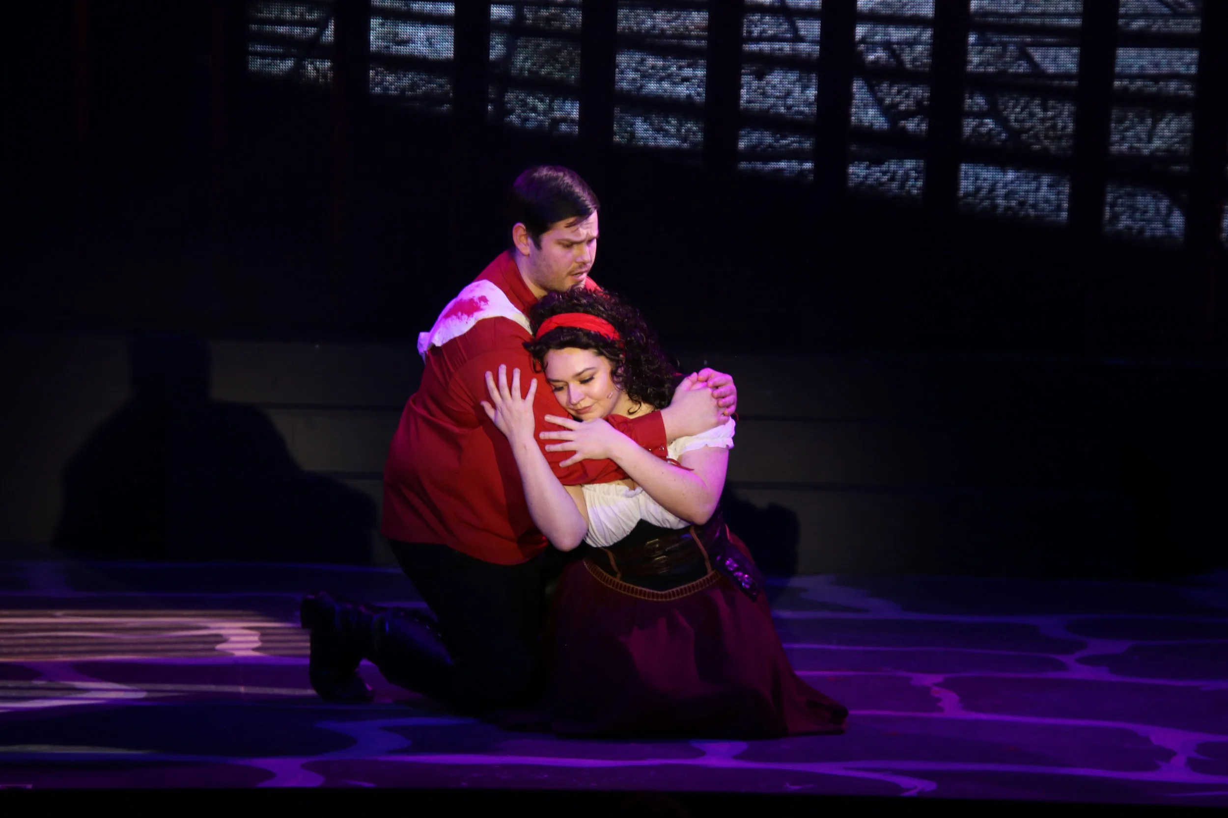 hunchback-of-notre-dame-2022-tender-embrace-kneeling-duet-red-tunic-burgundy-dress-phoenix-theatre-aberdeen-arts-centre-aberdeen-scotland.jpg