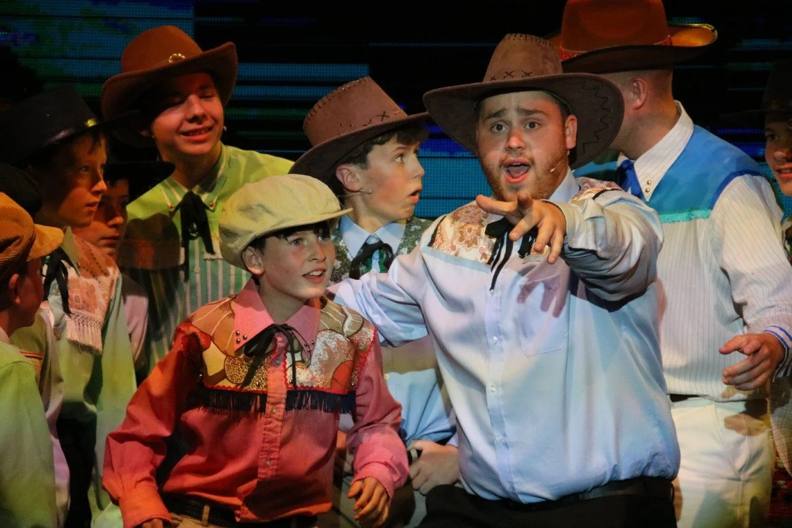 phoenix-youth-theatre-oklahoma-2023-cowboy-ensemble-lead-pointing.jpg