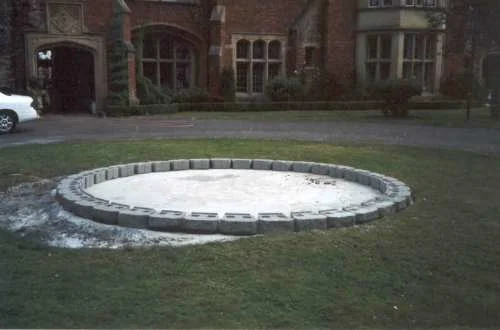 The first course of cement block is added.