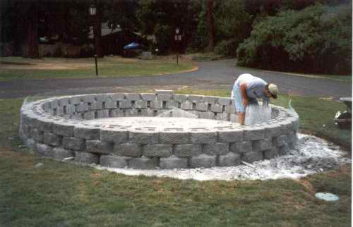  After the block walls are laid with cement, wire mesh is wrapped around the wall. 