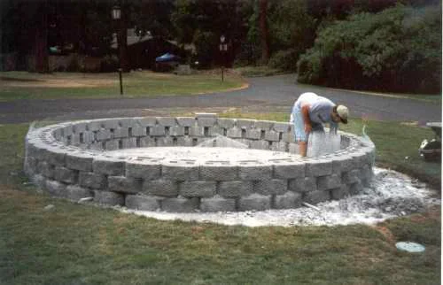 After the block walls are laid with cement, wire mesh is wrapped around the wall.