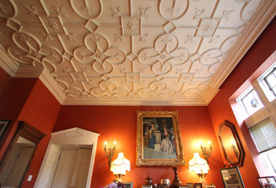 The gentleman's parlor, with moulded ceiling, sits just off the front entrance of the castle. (Photos by Janet Jensen/Staff Photographer)