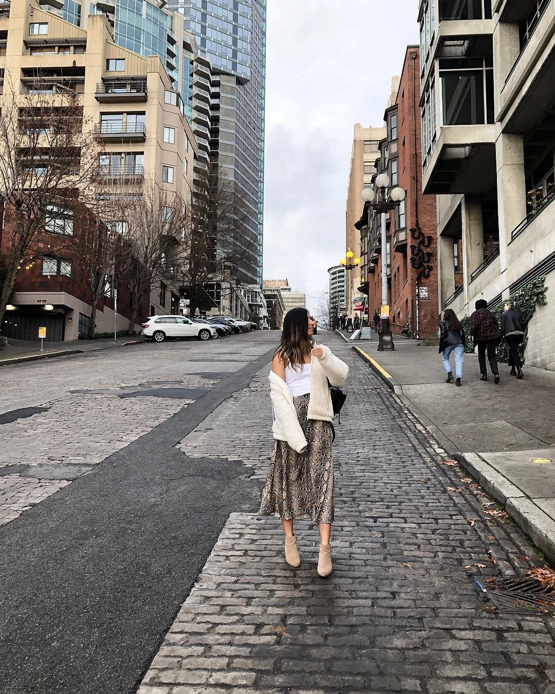 PacSun sherpa white jacket, Zara animal print skirt Brandy Melville white tank top, beige Aldo low-heel boots Urban Outfitters black mini backpack Photography by Reginald Guinto