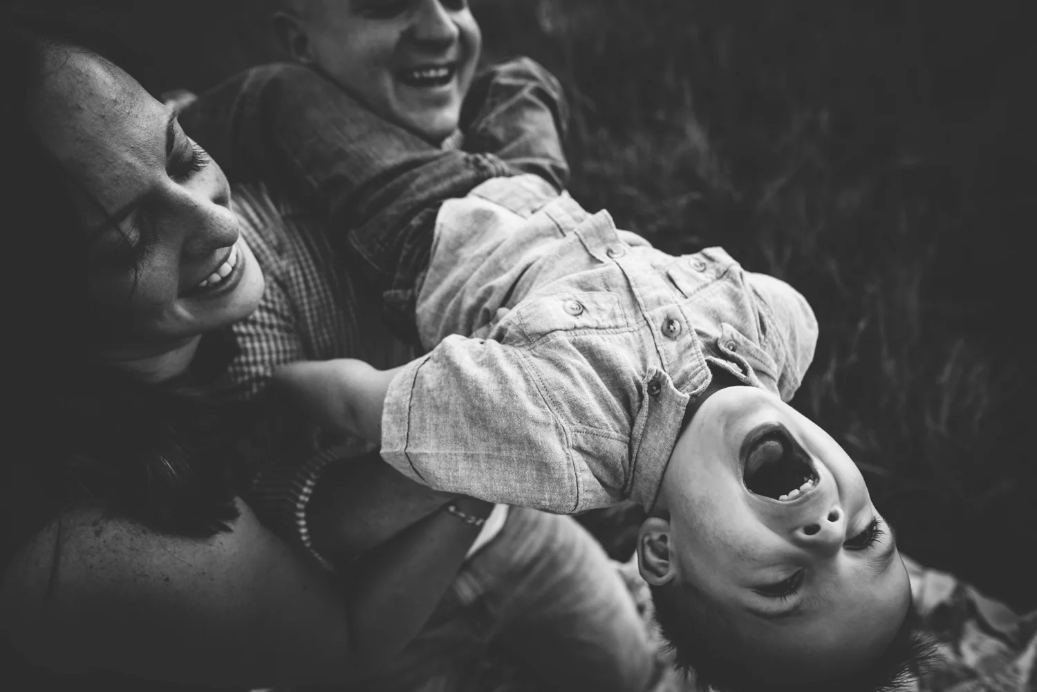 Mother and father snuggle with their laughing son during their session at Cheyenne Mountain State Park in Colorado Springs.
