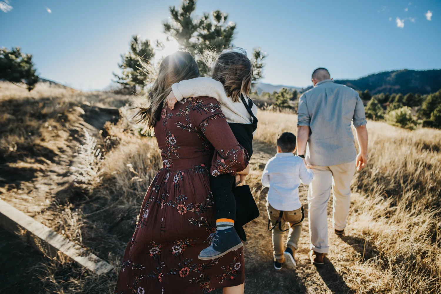 Boho hipster family hikes during photography session in Colorado Springs.