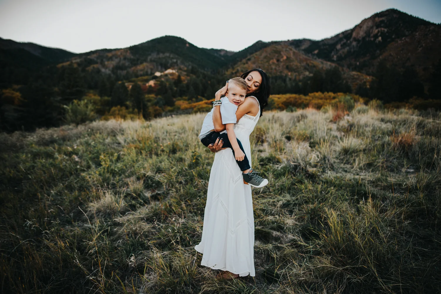 Sweet and stylish mother and son hug during photography session at Blodgett Peak Open Space in Colorado Springs.