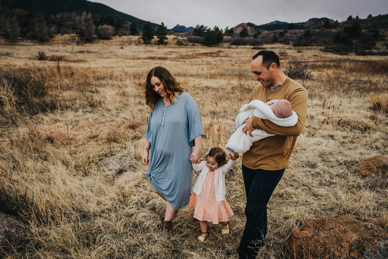 Newborn family session with big sister and mother and father in Colorado Springs open space.