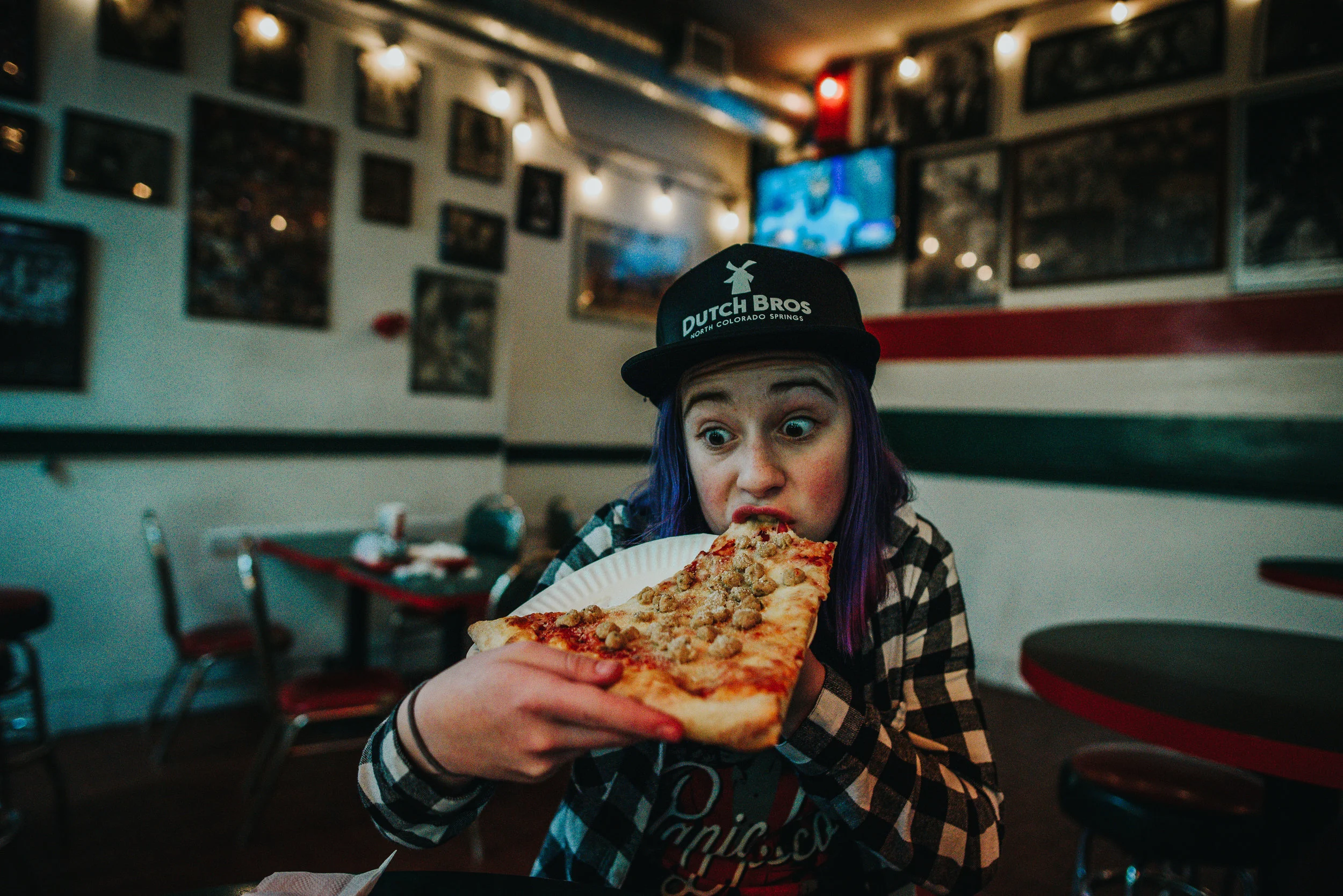 Teenage girl enjoys giant slice of pizza pie in Hollywood, California.