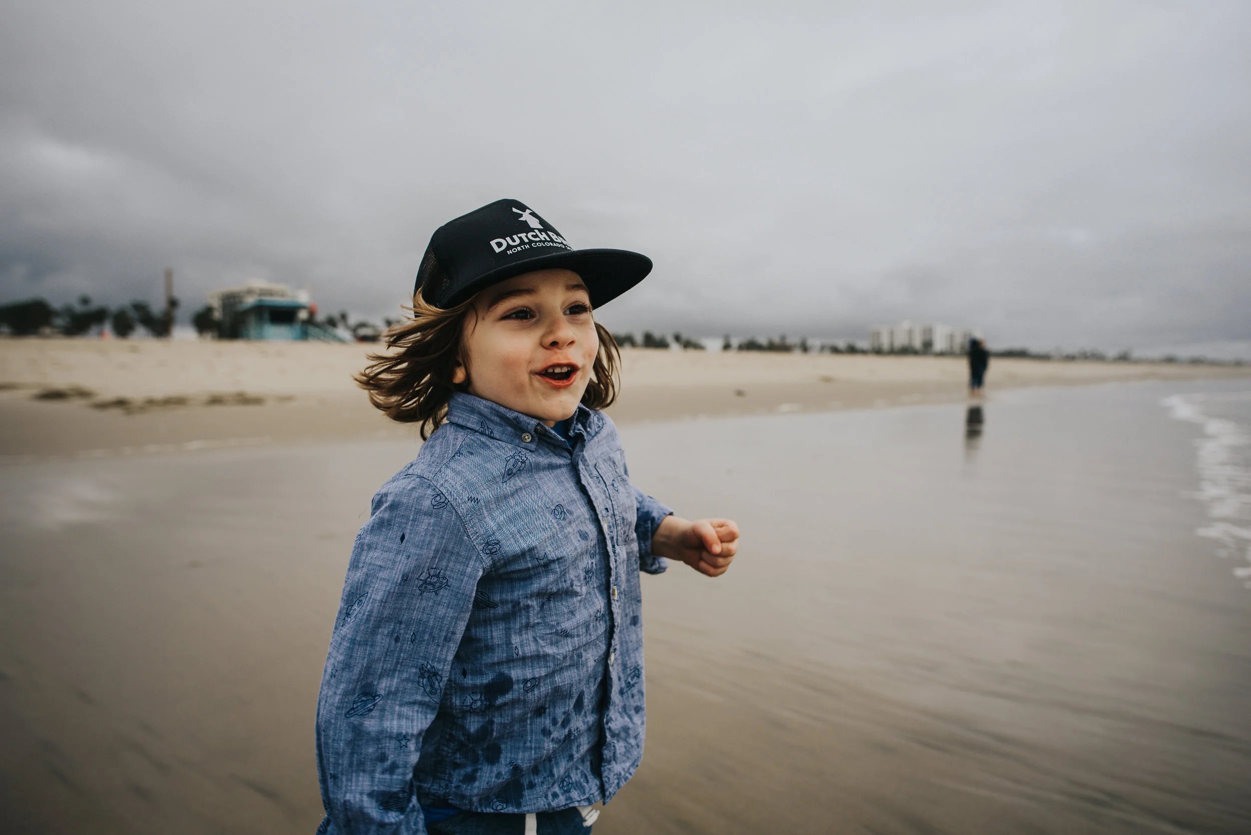 Little boy enjoying a run along the coast in California.